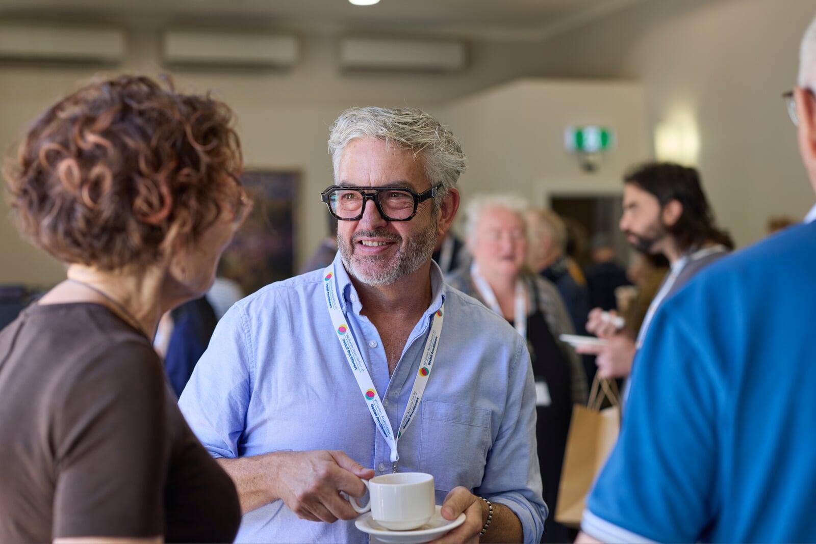 Conference participants talking together during a break